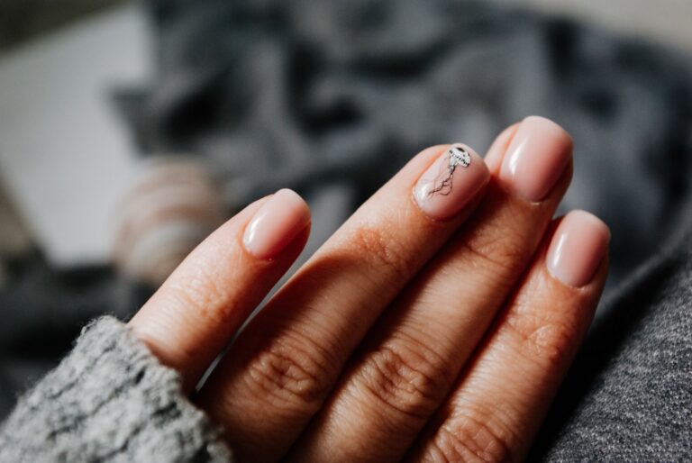 Elegant manicured nails with nail art design - NailBold nail care guide