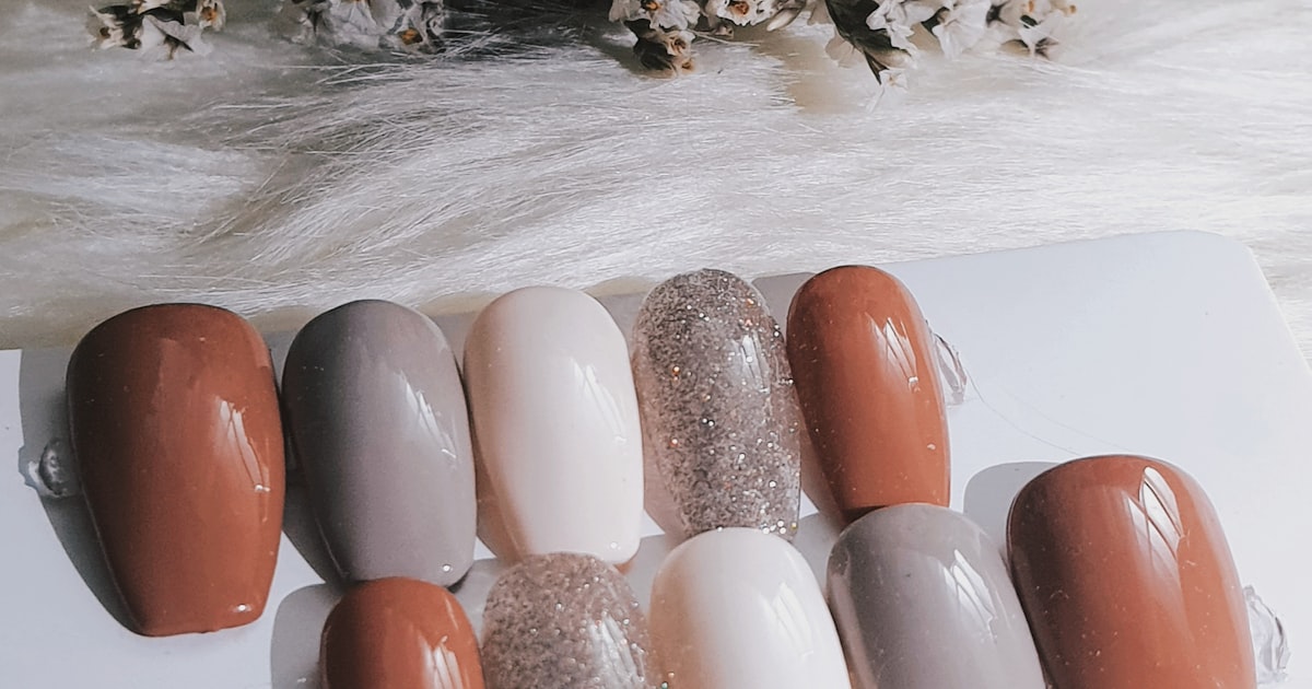Six brown nail polish shades displayed on a white surface
