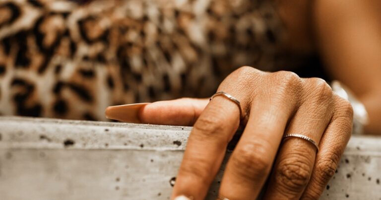 Brown nails with a glossy chocolate finish shown on a hand