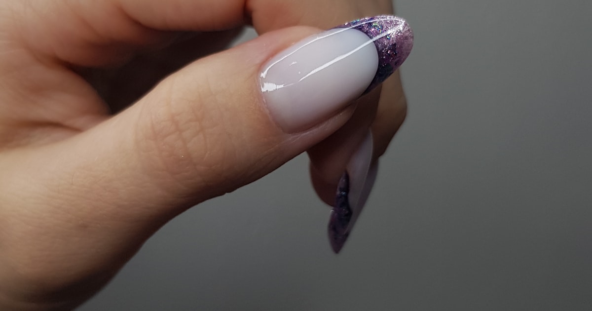 French tip cat eye nails with glitter accents on a soft base