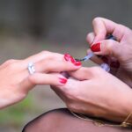 Woman resting her hands on a table before learning how to remove dip powder nails