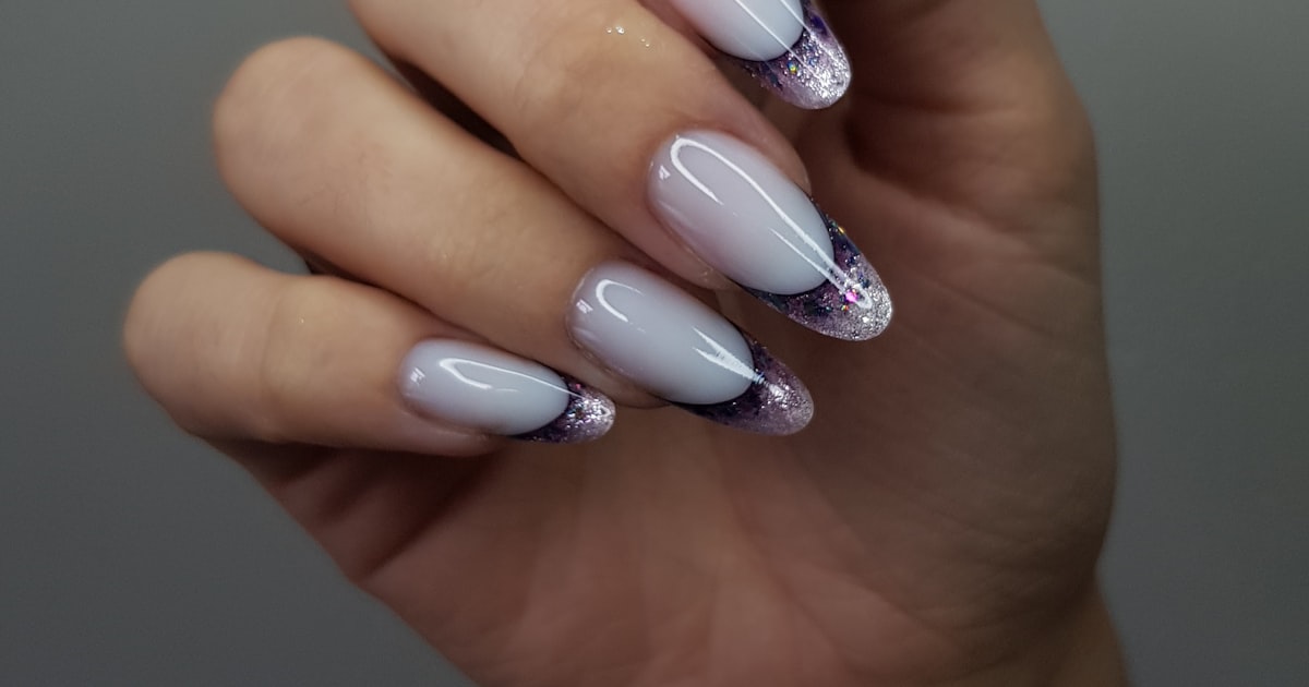 Lipstick nails with marbled white, purple, and black diagonal tips