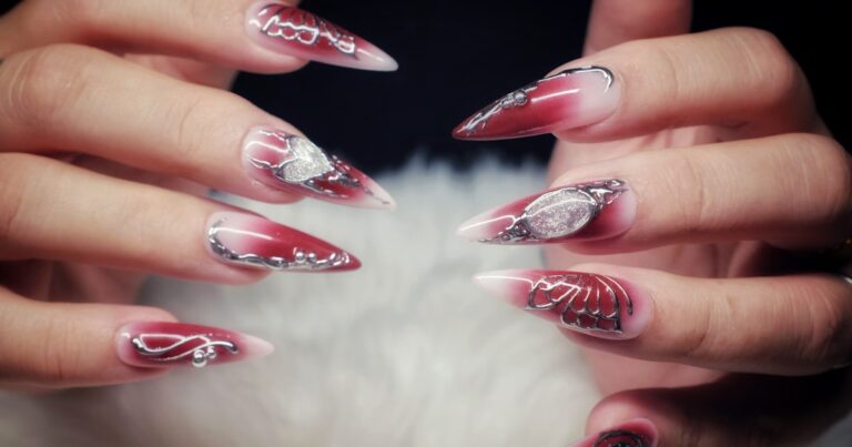 Lipstick nails 2026: long red manicure with a diagonal, angled tip