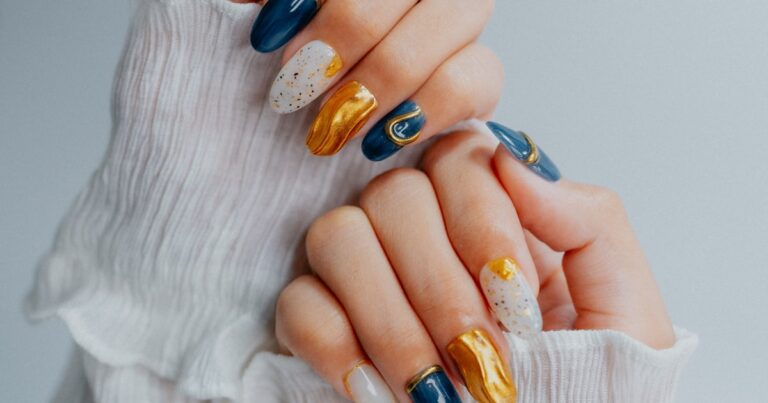 Nail stamping plates 2026: ornate navy, gold, and white stamped nail art