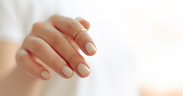 Nude nails with a soft beige finish shown on a hand