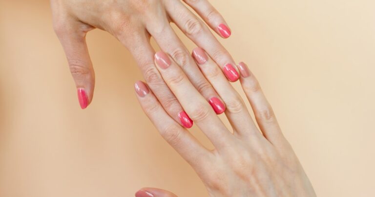 Hands with coordinating shades of semi-cured gel nail strips applied