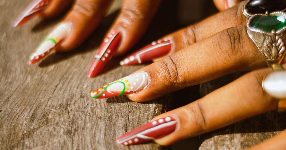 Neutral stiletto nails styled with layered rings