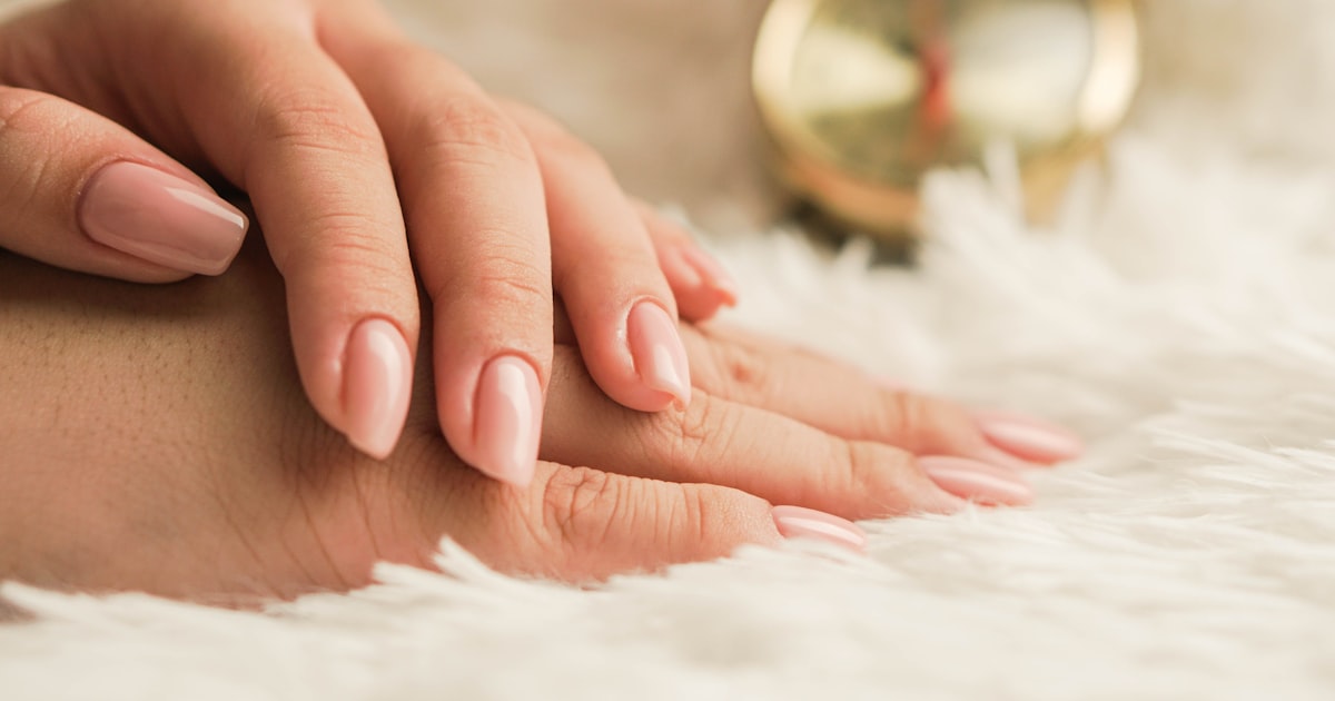 Classic nude ballerina nails on white surface