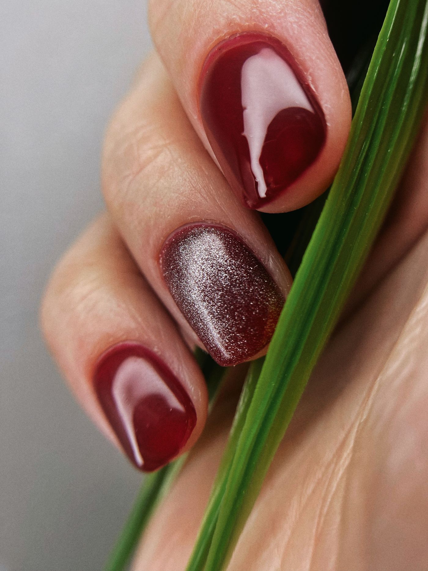 Deep burgundy fall nails with a shimmering velvet accent nail