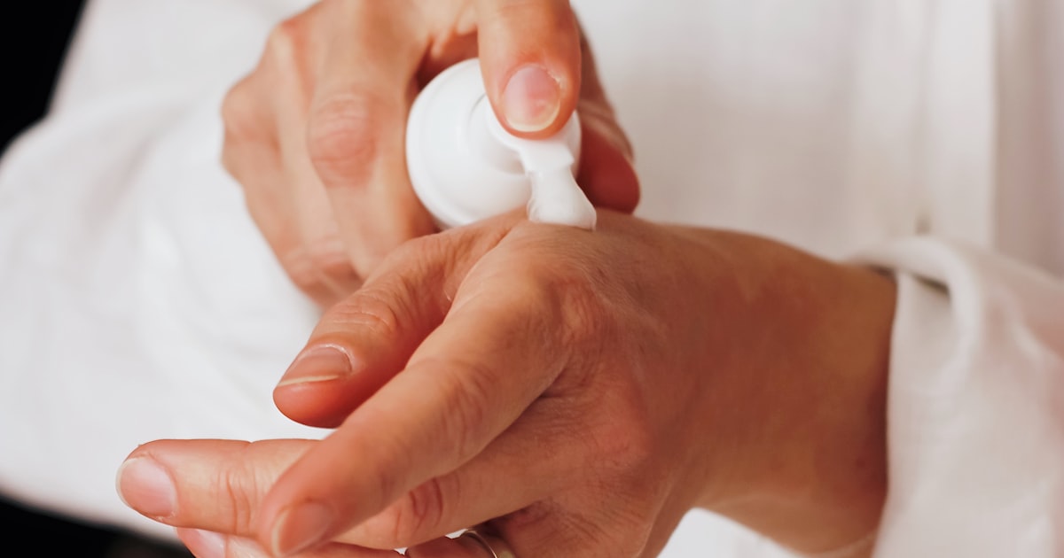 Applying hand lotion after learning how to remove dip powder nails safely