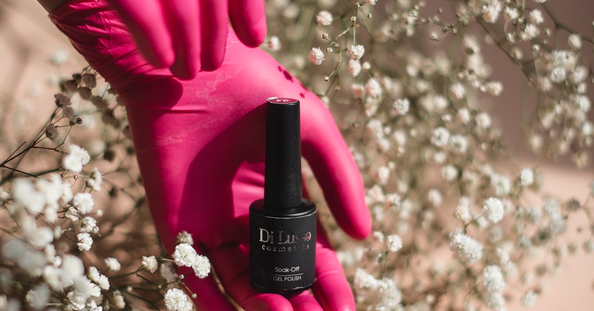 Holding a bottle of nail polish after removing gel nail polish at home