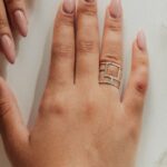 Nude almond nails on a relaxed hand, the most flattering nail shape for chubby fingers