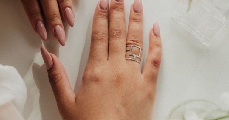 Nude almond nails on a relaxed hand, the most flattering nail shape for chubby fingers