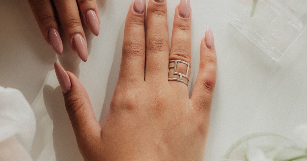 Nude almond nails on a relaxed hand, the most flattering nail shape for chubby fingers