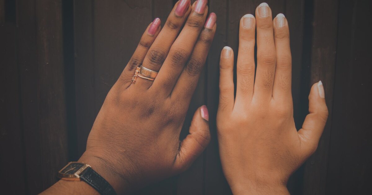 Two hands with different skin tones side by side showing manicured nails