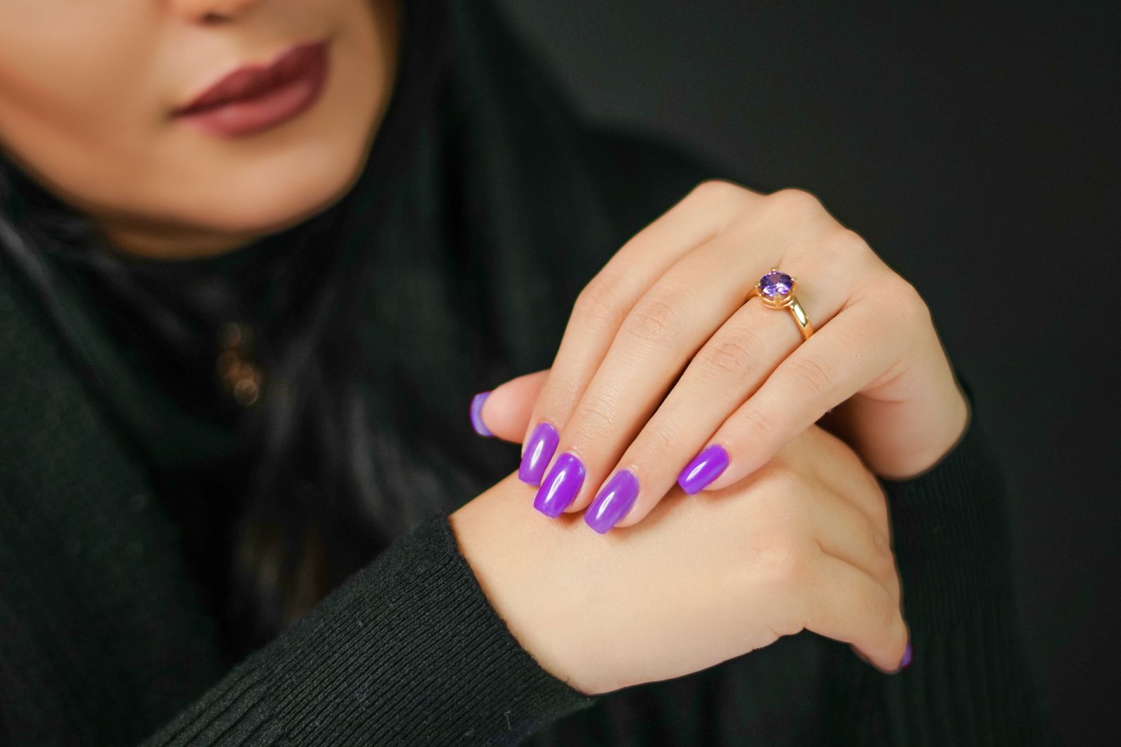 Purple nail designs: vivid violet square nails with an amethyst ring on a dark background