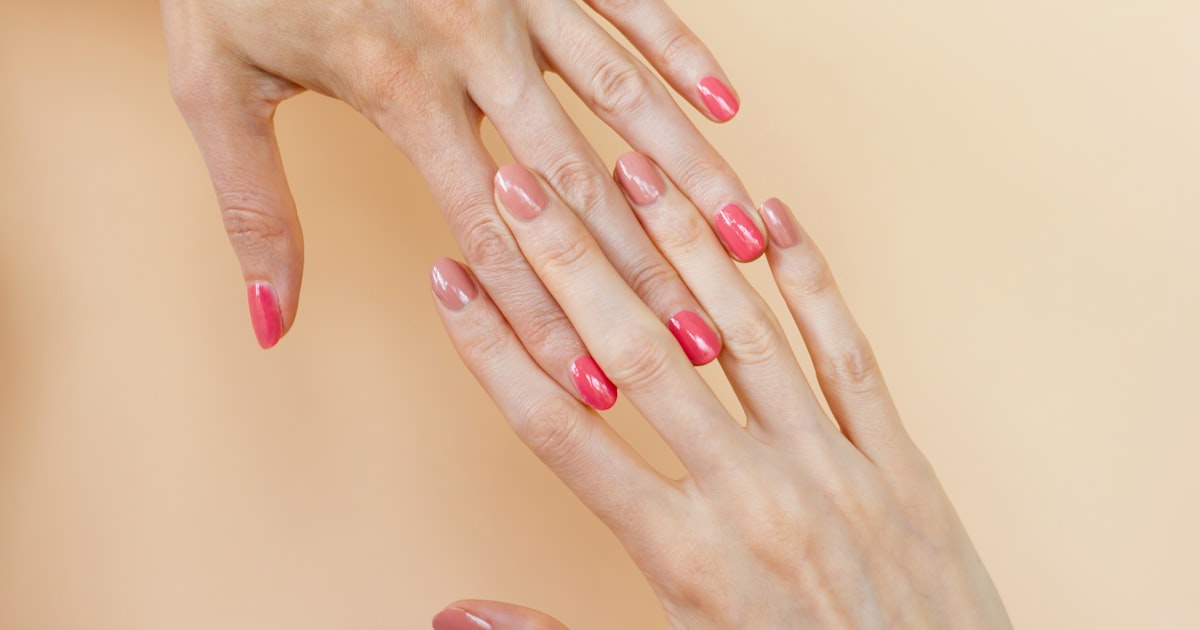 Hands with coordinating shades of semi-cured gel nail strips applied