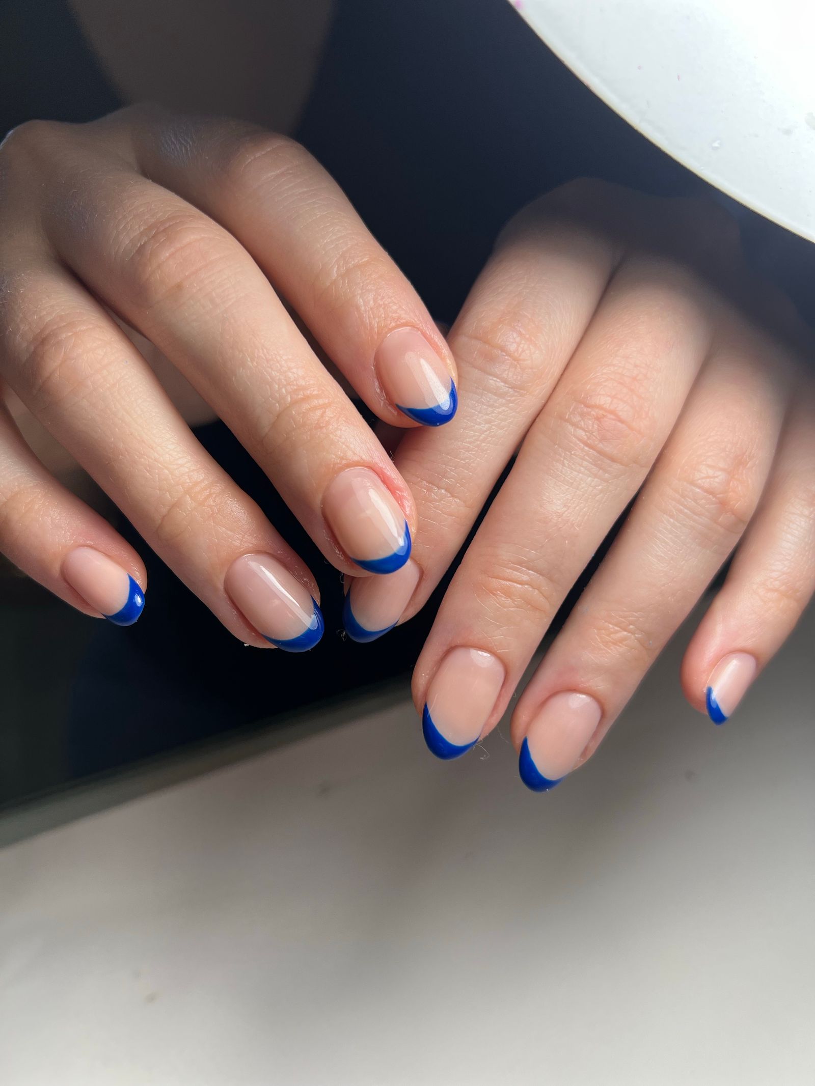 Surfside nails: blue-tipped wave French manicure in soft daylight